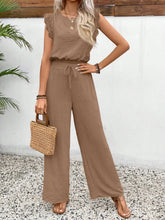 Lifestyle shot of the Taupe Papiloniya™ Lace Trim Set worn for an outdoor brunch, paired with sandals, a tan straw handbag, and platinum silver jewelry.