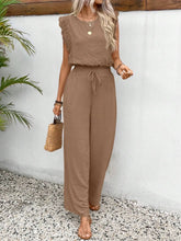 Model wearing the Papiloniya™ Lace Trim Round Neck Top and Pants Set in Taupe. Featuring lace trim top and wide-leg pants, styled with sandals.