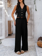 Model in black Quevella Duo Set, front view in a sunlit loft