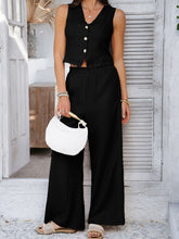 Model in Black Quevella Duo Set posing mid-walk in a sunlit loft space for a dynamic, confident look