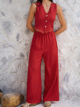 Model posing against loft wall in Rust Quevella Duo Set