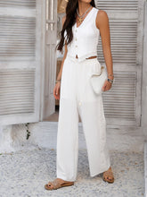 Model posing against loft wall in White Quevella Duo Set