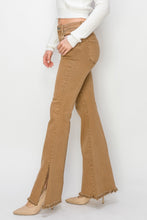 Model wearing RISEN Bailey jeans with heels to show side slits detail.