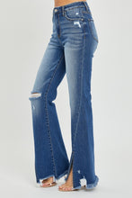 Side view highlighting front slit and distressed frayed hem detail