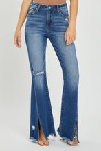 Walking shot of model wearing RISEN jeans to showcase flare and slit movement