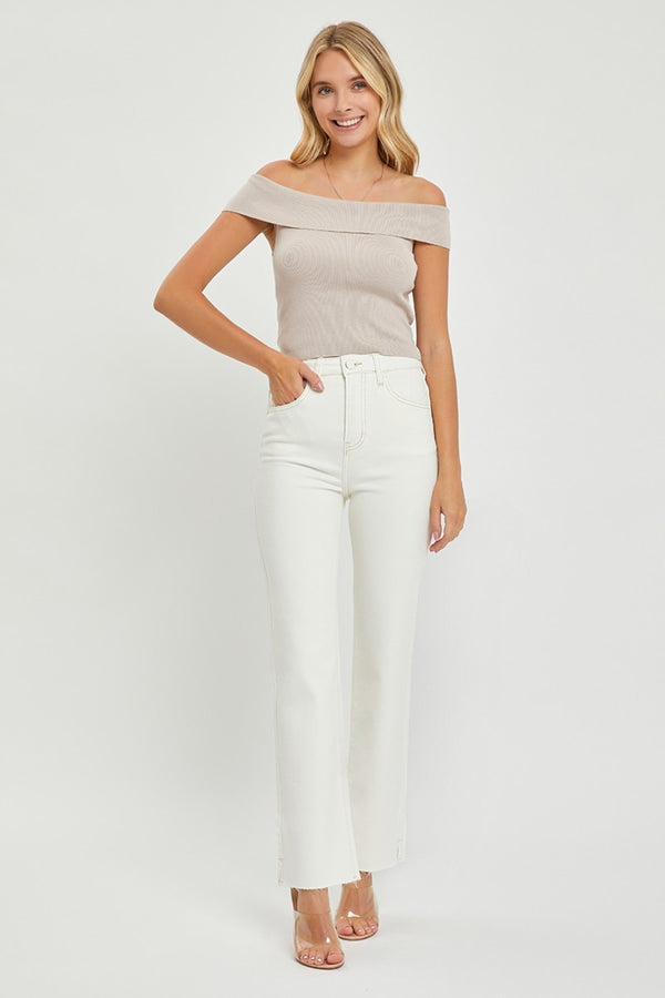A female posing from the front wearing cream RISEN Full Size High Rise Tummy Control Straight Jeans paired with a cream off-shoulder blouse, jewelry, and clear round open-toe heels.