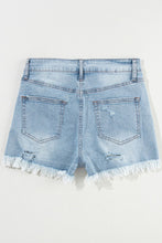 Flat lay of light blue distressed high waist denim shorts, back view featuring pockets and raw hemline.