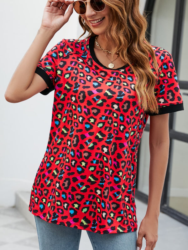 Model wearing a red leopard print round neck short sleeve tee paired with distressed denim shorts and layered necklaces.