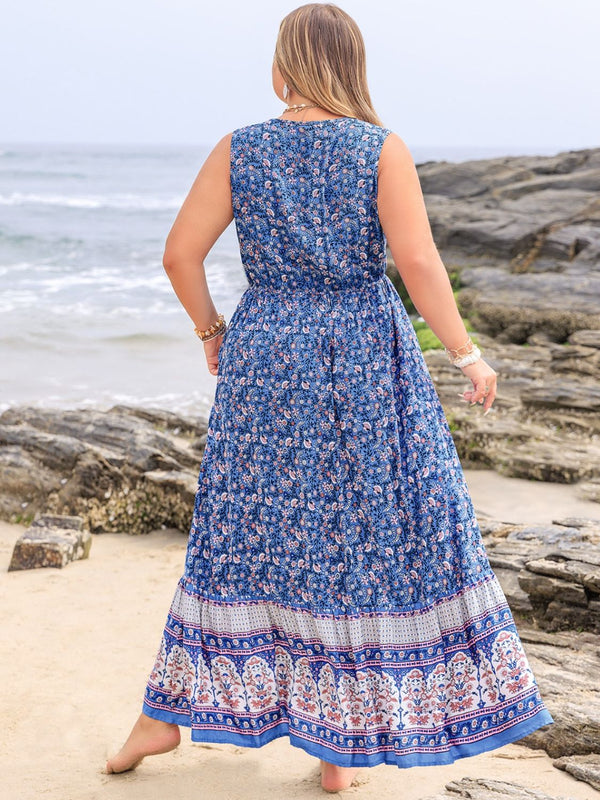 Back shot of a model posing on the beach bare feet wearing the royal blue Bohemysa Maxi.
