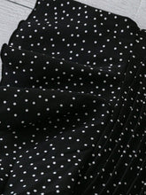 Close-up of Ruffled Sleeve detailing on the black EverDot Flutter Top.