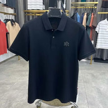 TexturaLoom Men’s Embossed Letter Polo Black Front View on Hanger.