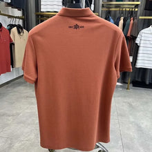 TexturaLoom Men’s Embossed Letter Polo Orange Back View on Hanger.