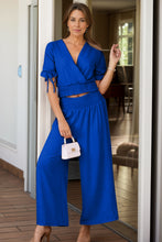 Model styled in Seerophant Ruffle Lounge Duo royal blue at tropical mansion event