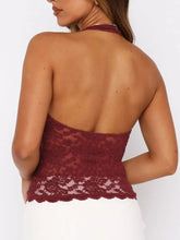 Backless burgundy lace design close-up highlighting soft floral motif and elegant cut.