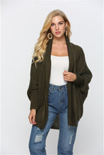 Front view of woman in Army Green SeraphinaWing Open Front Cardigan, hands in side pockets.