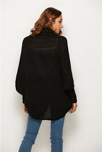 Back view of woman in Black SeraphinaWing Cardigan, showing chic, casual silhouette.