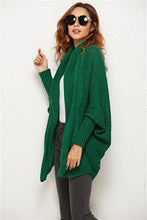 Side profile of woman in Green SeraphinaWing Cardigan, displaying the relaxed sleeve flow and open hemline.