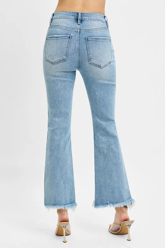 Back view of RISEN plus size bootcut jeans with high waist and cropped frayed hem.