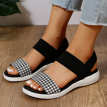 Model wearing PU Leather Open Toe Low Heel Sandals in black houndstooth