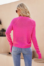 Back view of a woman wearing the Solavelle V-Neck Cardigan in hot pink, showcasing long sleeves and relaxed fit design.