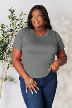Model smiling in vibrant gray solid short sleeve t-shirt