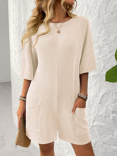 Model styled in tan Breezy Bold Romper paired with strappy heels at a casual business meeting.