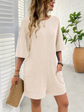 Close-up of tan Breezy Bold Romper, featuring the unique textured stripe pattern and the fabric's soft, moisture-controlling properties.