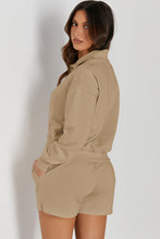 a woman in a tan  Half-Button Sweatshirt and Shorts Active Set poses for the camera, back angle.