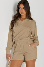 Model wearing a tan Half-Button Sweatshirt and Shorts Active Set styled with accessories for a dinner date.
