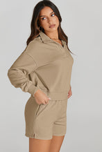 Woman wearing a tan outfit - Half-Button Sweatshirt and Shorts Active Set side view.