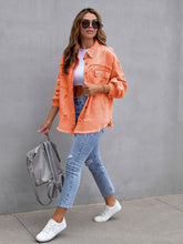 Front view of model in a tangerine CloudKitten Distressed Drop Shoulder Denim Jacket, featuring button-up front, relaxed silhouette, and distressed accents.