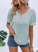 Model wearing Teal Wavelle Blouse paired with casual pants and accessories.