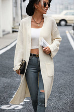 Woman wearing cream Thalora Cascade Cardigan, front open with pockets
