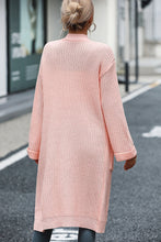 Back view of peach cardigan showing relaxed dropped shoulders and longline style