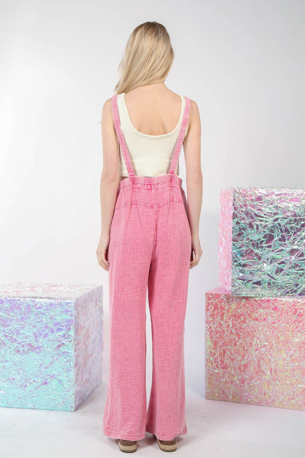 Model showcasing the back of the VERY J Texture Washed Wide Leg Overalls with adjustable straps and wide-leg fit, styled with loose hair and a relaxed pose.