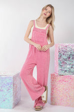 Model wearing VERY J Texture Washed Wide Leg Overalls with a fitted white tank top and white sneakers, standing casually in a sunlit urban setting.