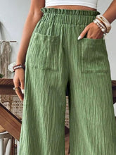 Close-up of waistband and frill accents on FrillEase matcha green trousers