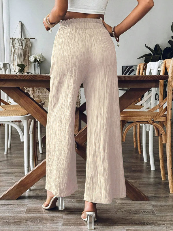 Back view of khaki Velonni™ trousers highlighting wide-leg flow