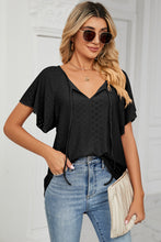 Detail shot of flutter sleeves and embroidered eyelets on Veluretta Mistflair Blouse in black.