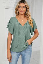 Model wearing the gum leaf Veluretta Mistflair Blouse at a garden brunch with friends.