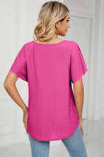 Hot pink Veluretta_Mistflair blouse from the back, highlighting playful eyelet embroidery.