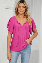 Model wearing the hot pink Veluretta Mistflair Blouse at a garden brunch with friends.