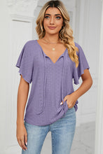 Model wearing the lavender Veluretta Mistflair Blouse at a garden brunch with friends.