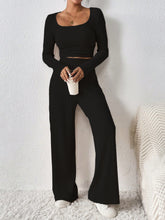 Verdelle Scoop Wide Leg Lounge Duo in black front view holding a coffee styled with accessories