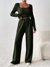 Woman in Verdelle Scoop Wide Leg Lounge Duo in army green at a resort.