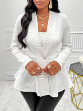 A woman wearing the white One Button Textured Peplum Cardigan at a business meeting paired with a white blouse, leather pants, jewelry, and heels. 