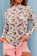 Model wearing a Printed Mock Neck Long Sleeve Bodysuit in white with trendy abstract print, paired with high-waisted jeans, standing against a neutral backdrop.