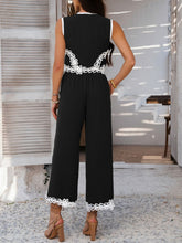Back view of model wearing Black Xyvello vest and pants set