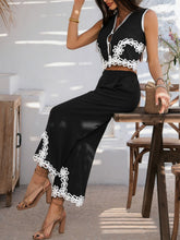 Model seated on cottage table in heels wearing Black Xyvello set