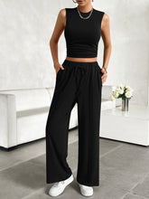 Zenvara Loungewear Set in black styled with white sneakers and accessories showcasing pockets detail